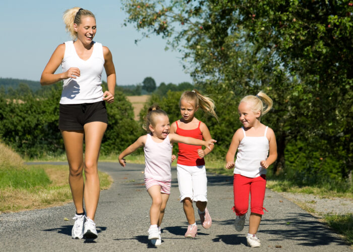 3 girls running with mom in sneakers
