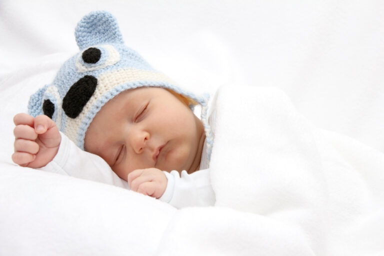 Sleeping baby in portable bed