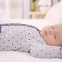 Baby asleep in sleeper pajamas