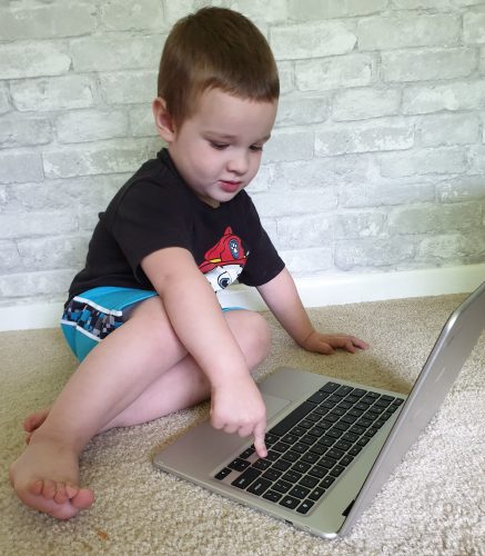 Baby boy at a computer earning a living