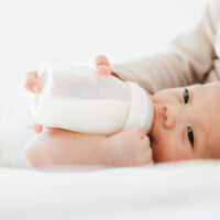 Baby Drinking from Glass Bottle