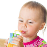 Baby Drinking Juice from a Straw