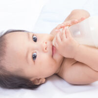 Baby Drinking Milk by Holding Her Own Bottle
