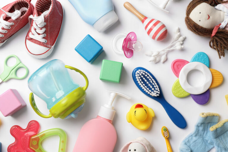 Flat lay composition with baby essentials on white background