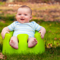 Happy Baby Boy in Bumbo Seat