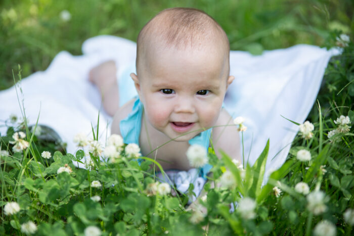 Baby girl in field with little hair