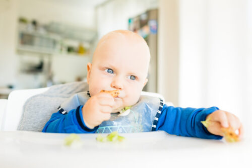 baby eating food with baby led weaning