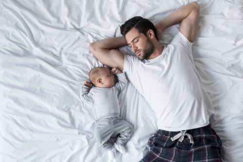 Dad and baby sharing a bed