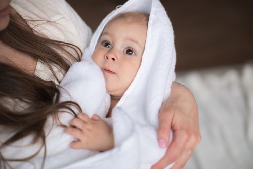 baby in white bath towel