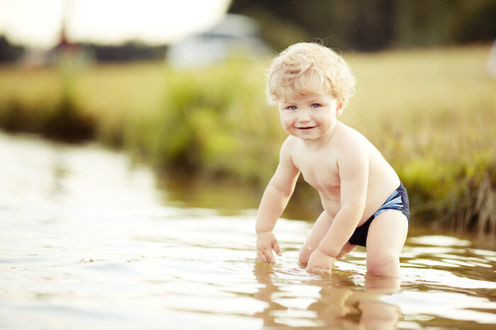 toddler in shallow water outside
