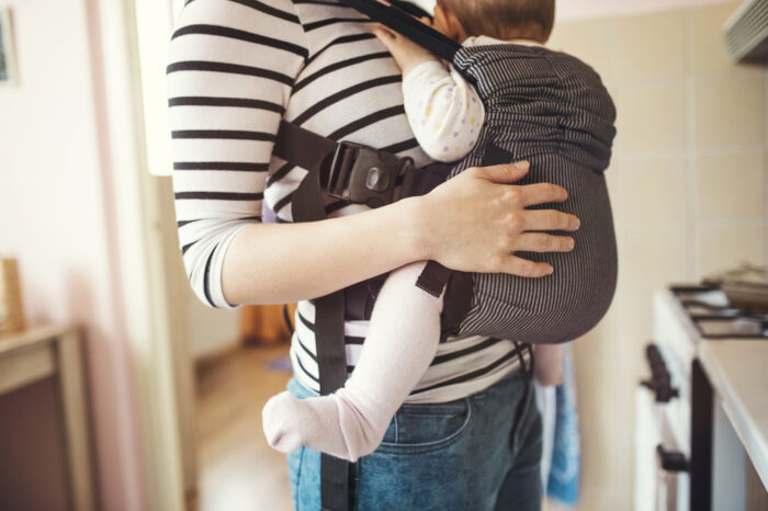 baby back facing in a baby carrier
