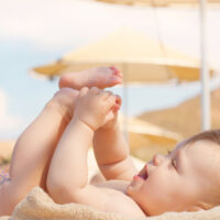 baby lounging at the beach