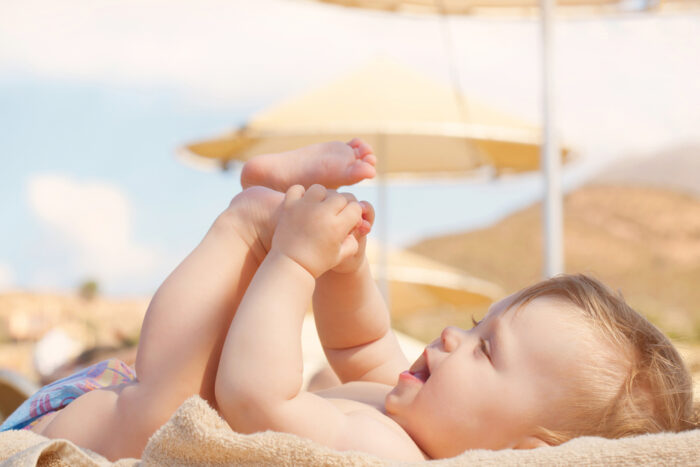 baby lounging at the beach