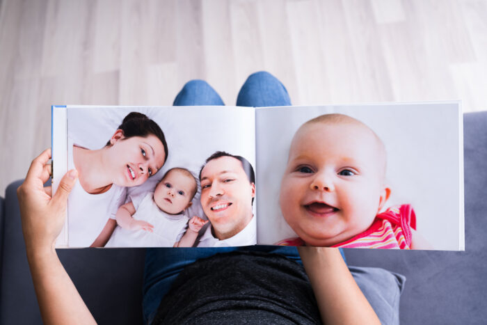 Woman Looking At Photo Album