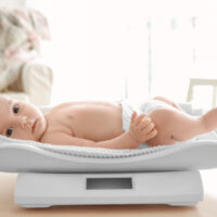 baby laying on a baby scale