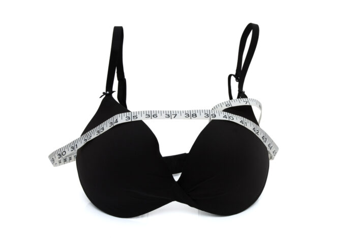 black bra with measuring tape around it