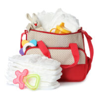 Large diaper bag with disposable diapers and baby toys on white background