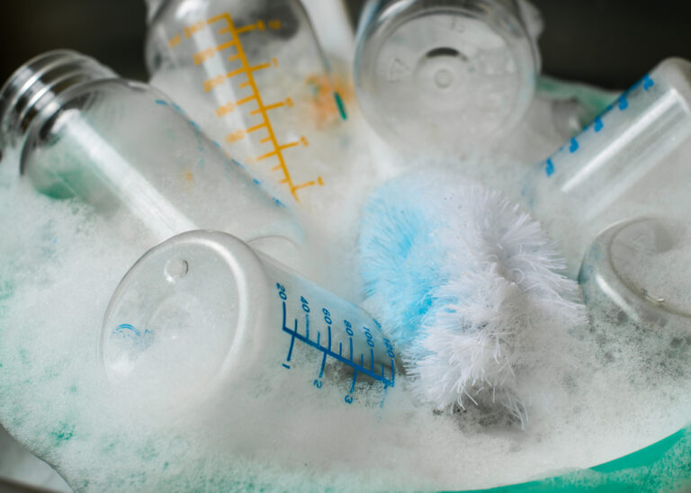 bottles washing in a bowl of soap