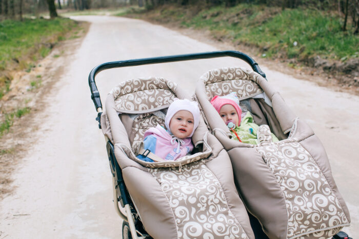 double jogging stroller with two babies in it