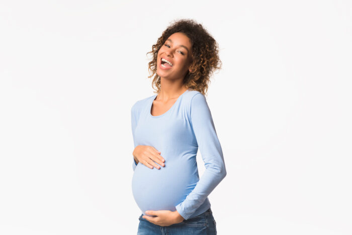 Studio shot of a Laughing pregnant woman