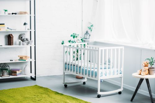 mini crib on wheels in nursery