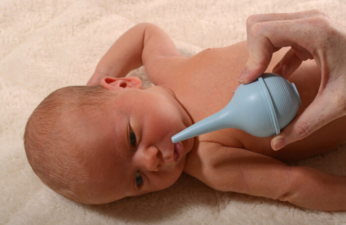 baby with nasal aspirator