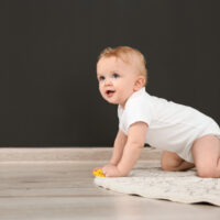 baby crawling on a rug