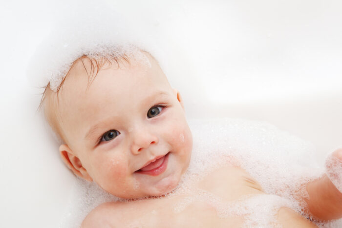 cute baby in bath with soap for baby