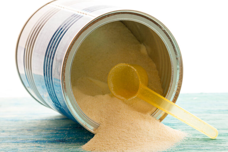 soy baby formula can with scoop spilling onto table