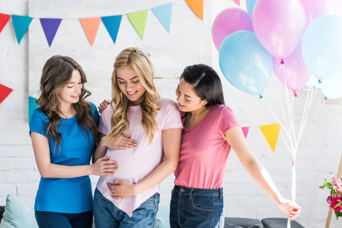 girls with balloons at baby shower