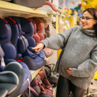 mother looking at car seats in store