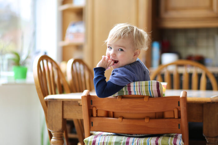 Child in Compact High Chair at Kitchen Table