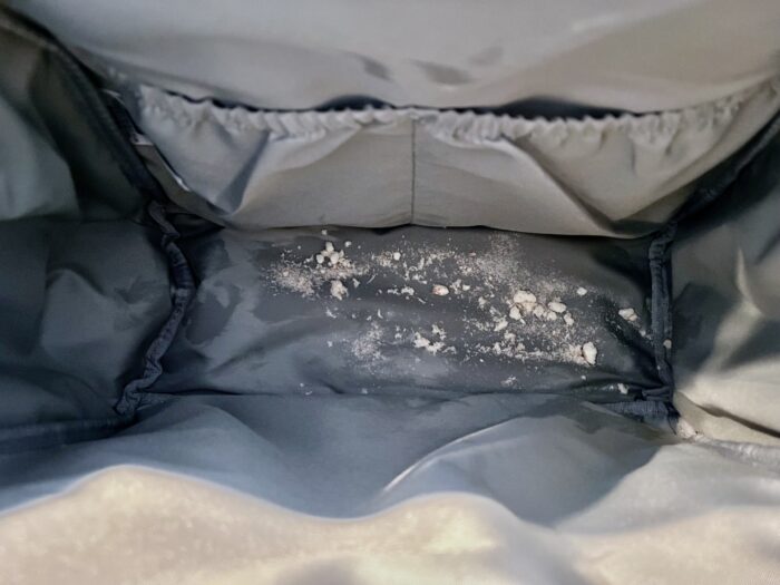 Crumbs sit at the bottom of a diaper bag to test how easy messes are to clean up.