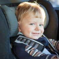Close up of toddler boy in car seat