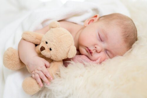 newborn-baby-sleeping-on-fur-bed