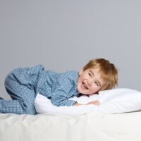 toddler laying on pillow