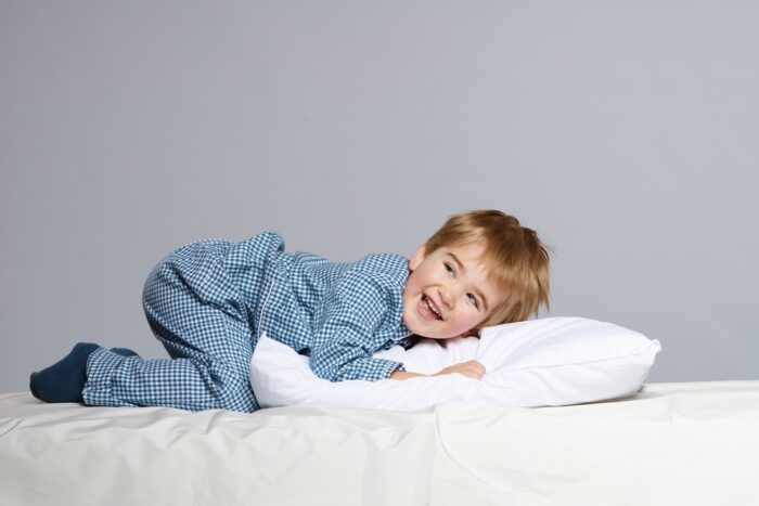 toddler laying on pillow