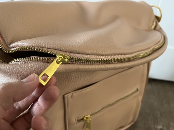 The metal hardware on the Fawn Design Original Diaper Bag feels premium.