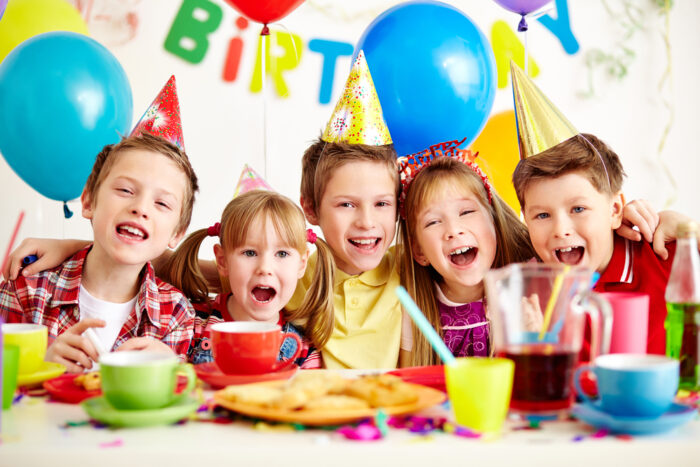 Group of kids celebrating a birthday at a party