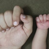 image of the hand of a parent and a child