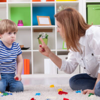 angry mother disciplining a disobedient toddler without yelling at him