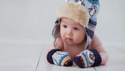 Baby with hat and mittens on