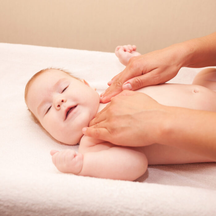 mother massaging baby's neck