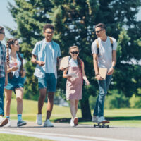 group of teenagers walking together outside