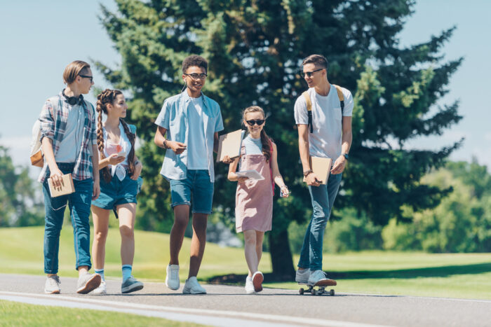 group of teenagers walking together outside