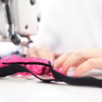 woman sewing together a headband