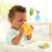 baby drinking from a sippy cup