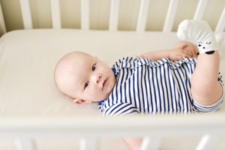 baby laying in crib awake