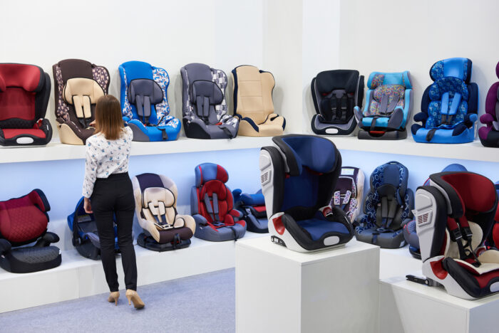 Mom looking at displays of car seats in store