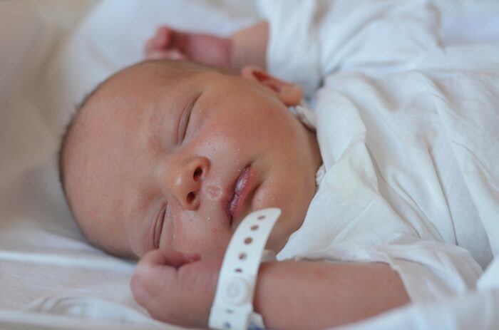 Sleeping baby with hospital bracelet